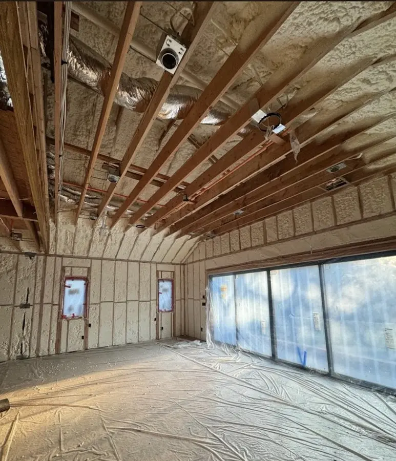 Interior walls and ceiling insulated with spray foam during new construction in North Madison